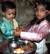 A girl ties rakhi on her brother's wrist in Gurgaon.