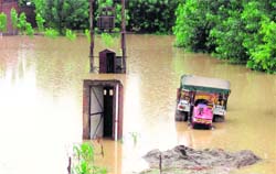 A tractor and an electricity transformer submerged in a flooded field in Una on Saturday