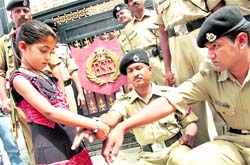 A girl ties a rakhi on the wrist of a BSF jawan on Raksha Bandhan in Jalandhar on Saturday