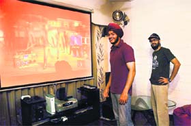 Jai Inder Singh (L) with his gaming console