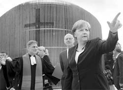 German Chancellor Angela Merkel gestures as she attends the commemorative ceremony of the construction of the Berlin Wall at the Bernauer Strasse Memorial on Saturday. Berlin marks the 50th anniversary of the building of the Berlin Wall in memory of those who died trying to flee to the West