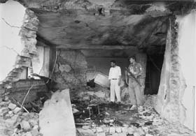 Security officials examine the site of a suicide attack on a governors compound in Charikar on Sunday
