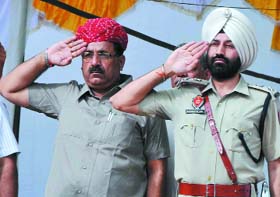 Transport Minister Surjeet Jyani takes the salute in Bathinda.