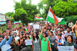 Youth hold a demonstration in protest against Annas arrest, in Dehradun on Tuesday.