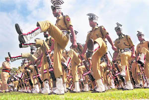 Police personnel take part in the march past.