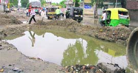 Natures wrath A pit full of rainwater on the Rahon road in Ludhiana on Tuesday.