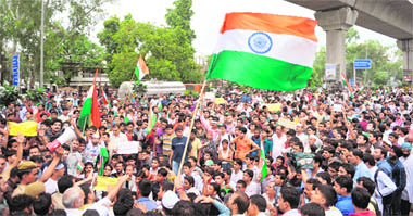 Supporters of Anna Hazare raise slogans outside Chhatrasal Stadium in New Delhi on Tuesday.  AFP