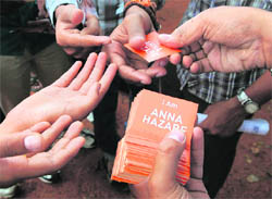 A supporter distributes stickers in Bangalore on Tuesday.  AFP