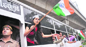 Supporters of Anna Hazare raise slogans after their arrest in New Delhi. Tribune photo: Mukesh Aggarwal