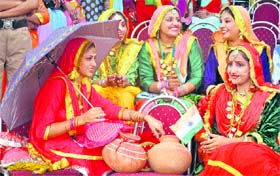 Gidha dancers with Tricolour in their hands wait to perform during the Independence Day celebrations at the Yadvindra Stadium in Patiala on Monday.