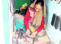 Darshini Devi mends shoes in Chamba village in Tehri Garhwal district.