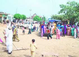 Villagers block the Tohana-Hisar road, demanding uninterrupted power supply to Samain village in Fatehabad on Wednesday