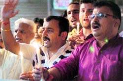 Locals participate in a candle-lit march in support of Anna Hazare at the Gandhi Chowk in Jammu on Wednesday