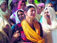 Grieving relatives of a murdered woman outside the GMCH mortuary in Jammu on Wednesday