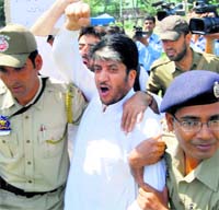 Separatist leader Shabir Ahmad Shah and his supporters being detained by policemen in Srinagar on Wednesday