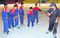 A coach gives ice skating tips to young enthusiasts in Dehradun 