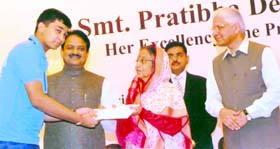 Arsh Shah Dilbagi, a Class IX student of DAV Public School, Thermal Colony, Panipat, receives an award from President Pratibha Patil in Delhi.