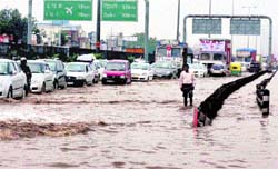 Vehicles move at a snails pace on a waterlogged road at Hero Honda Chowk in Gurgaon