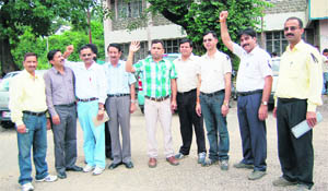 Members of the Himachal Pradesh Government College Teachers Association protest in Dharamsala 