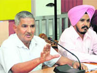 Rajwinder Singh Raju (left), president of the National Crime & Human Rights Protection Society, addresses the media in Jalandhar.