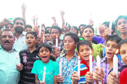 Followers of social activist Anna Hazare carry out a candlelight march in his support in Amritsar on Thursday. 