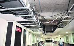 A gaping hole caused by the fall of a portion of the false ceiling in the corridor of the MC administrative complex in front of the office of the Municipal Commissioner in Jalandhar 