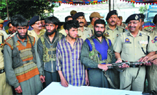 One of the four militants hands over his weapon to a police officer in Jammu on Thursday. 