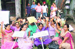 Members of the NRHM union stage a protest in support of their demands. 