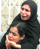 Pakistani women mourn the death of their family member in Karachi on Thursday.