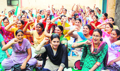Members of NRHM Employees Union hold a dharna against the state government in Amritsar on Friday