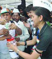 A supporter of Anna Hazare collects money at the Ramlila Ground in New Delhi on Friday. 