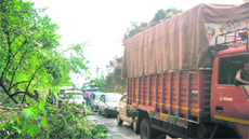 Vehicles stranded near Bhawali in Nainital district due to landslides on Friday. 