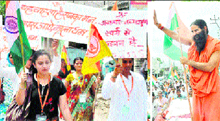 Youth activists take part in a procession against graft in Haridwar on Friday; and (right) Yoga guru Ramdev waves to the crowd during his padyatra.