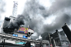 Smoke billows out of the shop near Middha Chowk where a fire broke out in Ludhiana on Friday