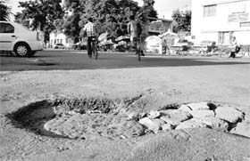 A potholed road posing a danger to the lives of two-wheeler riders at Sector 7 in Panchkula