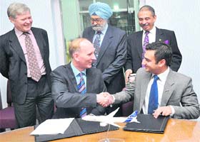 Ian P Veall of Donald H Bunker and Associates, the only aviation law firm in the Arabian Gulf, along with Nitin Sarin of Sarin & Co., signing the formal affiliation between the two law firms. Behind: (from right) Scott Slessor, Consul General of Canada, Justice SS Sodhi, president, Sarin Memorial Legal Aid Foundation, and Manmohan Lal Sarin, secretary general of the foundation, in Sector 4, Chandigarh, on Saturday