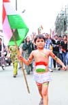 A boy takes part in a protest rally in support of Anna Hazare in Karnal 