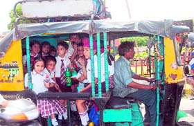 Children being ferried to school in an overcrowded autorickshaw in Jalandhar.
