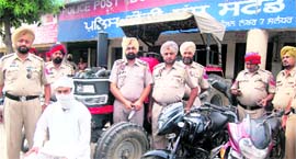 The accused in police custody with the stolen vehicles.