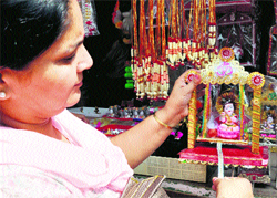 A devotee purchases an idol of Lord Krishna for Janamashtami in Jammu