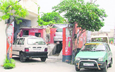 A view of a garage where cars are being fixed at Aman Nagar in Ludhiana.  
