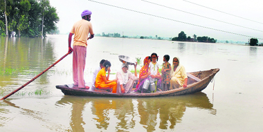 A farmer shifts his family to a safer place in Mand area of Kapurthala district; (below) residents of Mohar Jamsher village in Fazilka loading their belongings on a boat on Saturday