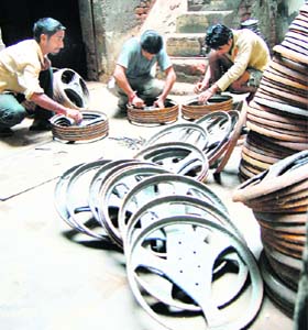 Labourers work in a fan manufacturing factory