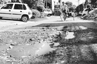 a potholed road crying for repair at Sector 8 in Panchkula.