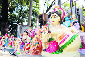 The idols of Lord Krishna are sold on the roadside on the eve of Janmashtami in Dehradun on Sunday.