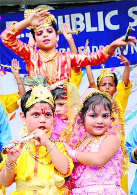 Schoolchildren dressed as Lord Krishna and Radha during Janmashtami festival celebrations at a school in Karnal