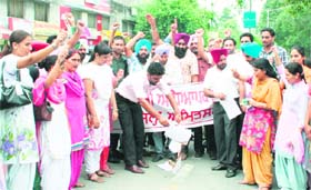 Members of the Sikhya Karmi Adhyapak Union burn copies of the agreement in Amritsar on Sunday