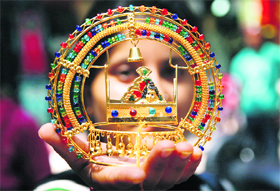A devotee buys an idol of Lord Krishna on the occasion of Janamashtami in Jammu on Sunday. 