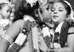 A child dressed as Lord Krishna kisses another dressed as Krishnas consort Radha as they pose during a fancy dress competition held during Janmashtami celebrations at Iskcon Temple in Bangalore on Sunday