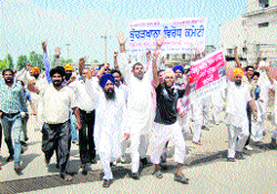 Residents raise slogans against pollution by a meat plant in Dera Bassi